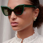 close up of face of a woman wearing emerald green Andromeda (extreme cat-eye) sunglasses